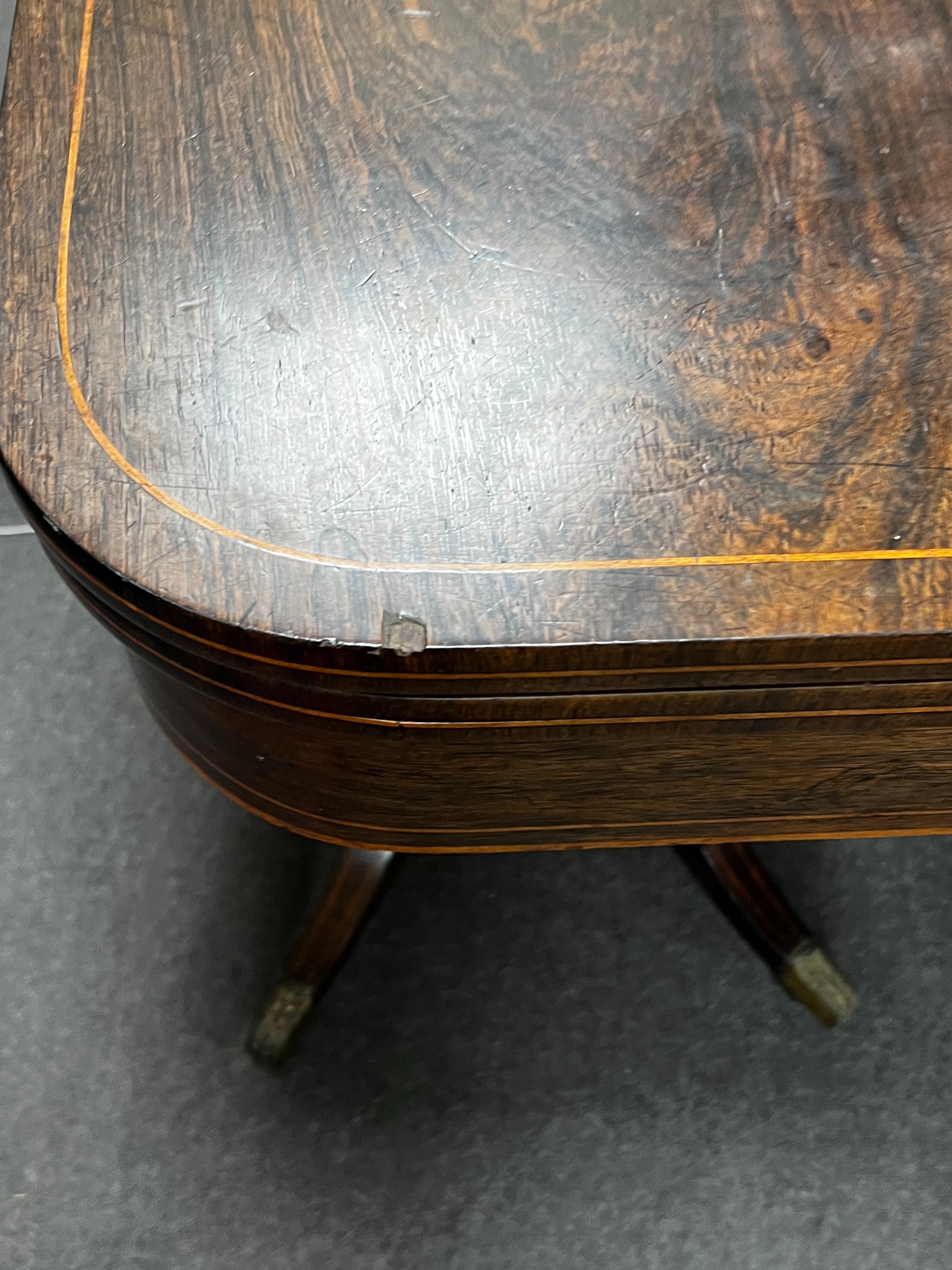 A Regency inlaid rosewood D shaped folding card table, width 86cm, depth 44cm, height 74cm